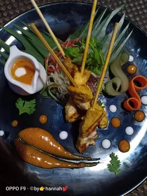 a blue plate topped with food on a table at Saengsuree Villas Koh Yao Yai in Ko Yao Yai