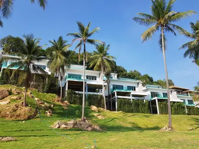 a large house on a hill with palm trees at Saengsuree Villas Koh Yao Yai in Ko Yao Yai