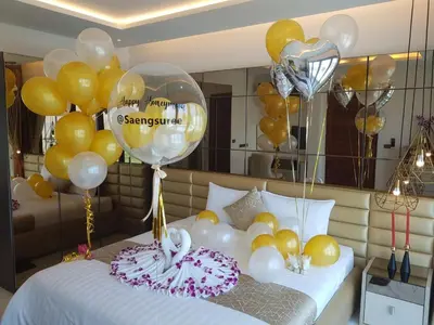 a bedroom with balloons and a bed with two cakes at Saengsuree Villas Koh Yao Yai in Ko Yao Yai