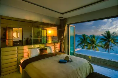 a bedroom with a large bed and a large window at Saengsuree Villas Koh Yao Yai in Ko Yao Yai