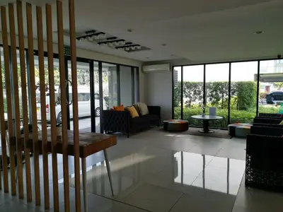 a living room with a couch and a table at 4 Floor - Centrio Condominium in Phuket town in Phuket Town