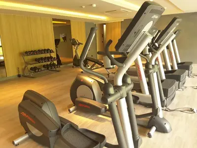 a gym with a bunch of treadmills and exercise bikes at Baan Mai Khao in Mai Khao Beach