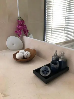 a bathroom counter with a sink with towels and a mirror at Baan Mai Khao in Mai Khao Beach