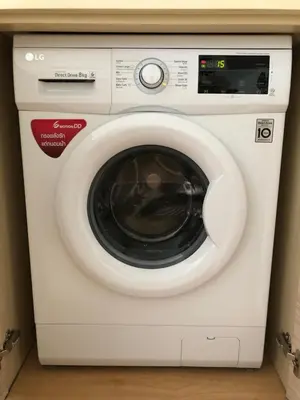 a white washing machine sitting in a room at Baan Mai Khao in Mai Khao Beach