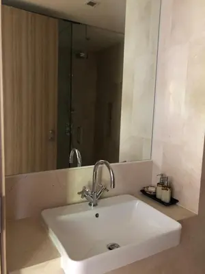 a white sink in a bathroom with a mirror at Baan Mai Khao in Mai Khao Beach