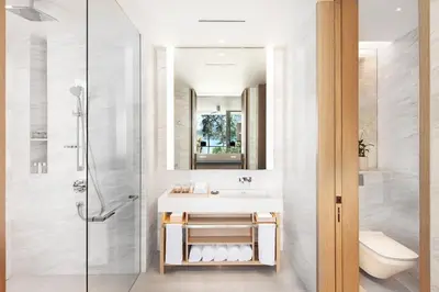 a bathroom with a sink and a shower at Twinpalms MontAzure Phuket in Kamala Beach