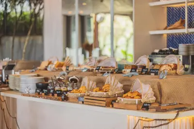 a buffet of bread and pastries on a table at Twinpalms MontAzure Phuket in Kamala Beach
