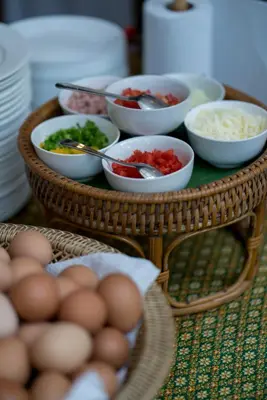 a tray of food with bowls of vegetables and eggs at Kata Tranquil Villa - SHA Plus in Karon Beach
