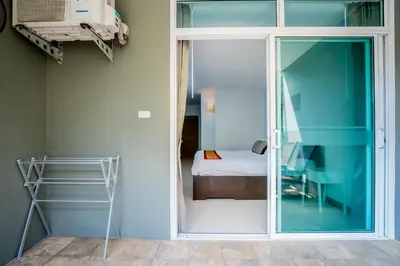 a room with a glass door leading to a bedroom at Kata Tranquil Villa - SHA Plus in Karon Beach