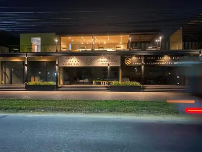 a building at night with a street in front of it at The Gallery Hotel Nai Harn in Nai Harn Beach