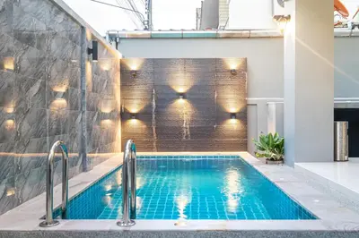 a swimming pool in a house with lights on the wall at Prime Patong-5BR-6BR pool villa See photo BEFORE BOOK in Patong Beach