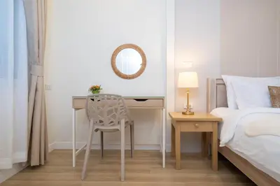 a bedroom with a desk and a bed and a mirror at Prime Patong-5BR-6BR pool villa See photo BEFORE BOOK in Patong Beach