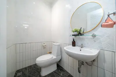 a bathroom with a white toilet and a sink at Prime Patong-5BR-6BR pool villa See photo BEFORE BOOK in Patong Beach