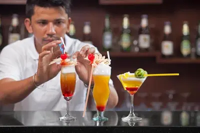 a man sitting at a bar with three drinks at Seeka Boutique Resort in Patong Beach