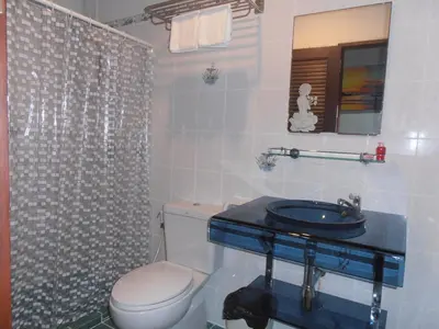 a bathroom with a toilet and a sink and a shower at Sue@Cozy Guesthouse in Kata Beach