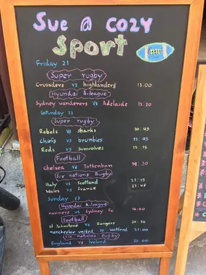 a chalkboard menu board with a sign for aeryery support at Sue@Cozy Guesthouse in Kata Beach