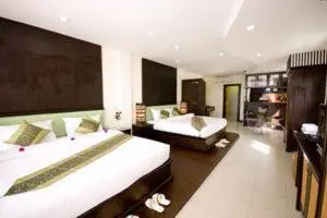 a large bedroom with two beds and a couch at Royal Nakara Ao Nang in Ao Nang Beach