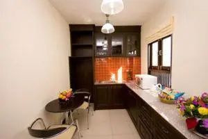 a kitchen with a counter and a table and chairs at Royal Nakara Ao Nang in Ao Nang Beach