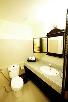 a bathroom with a toilet and a sink at Royal Nakara Ao Nang in Ao Nang Beach