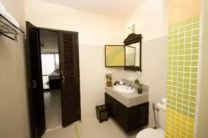 a bathroom with a sink and a toilet and a mirror at Royal Nakara Ao Nang in Ao Nang Beach