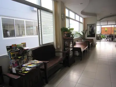 a waiting room with benches and tables and windows at Royal Nakara Ao Nang in Ao Nang Beach