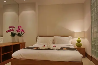 a bedroom with a bed with two dolls on it at Pearl of Naithon in Nai Thon Beach