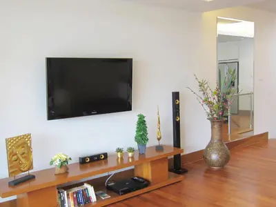 a living room with a flat screen tv on a wall at Pearl of Naithon in Nai Thon Beach