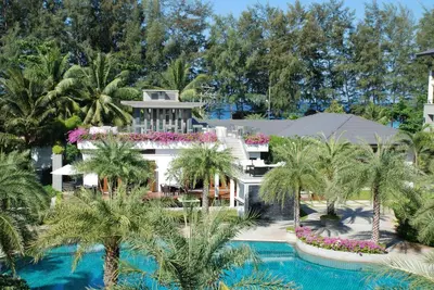 an aerial view of a resort with palm trees and a swimming pool at Pearl of Naithon in Nai Thon Beach