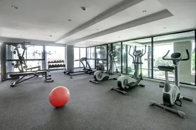 a gym with exercise equipment and a red ball in the middle at WOW Apartment at Unity Patong in Patong Beach