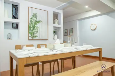 a dining room with a table with white dishes on it at Enjoy Sunset Rainbow Alley - WOW Townhouse at Patong Hill in Patong Beach