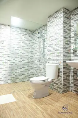a bathroom with a white toilet and a shower at Enjoy Sunset Rainbow Alley - WOW Townhouse at Patong Hill in Patong Beach