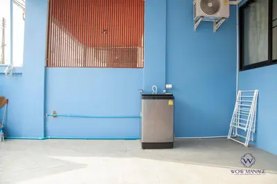 a blue wall with a trash can in a room at Enjoy Sunset Rainbow Alley - WOW Townhouse at Patong Hill in Patong Beach