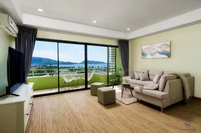 a living room with a couch and a television at Enjoy Sunset Rainbow Alley - WOW Townhouse at Patong Hill in Patong Beach