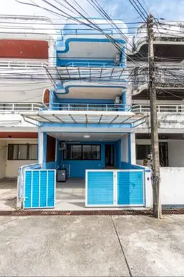 a building with blue doors in front of it at Enjoy Sunset Rainbow Alley - WOW Townhouse at Patong Hill in Patong Beach