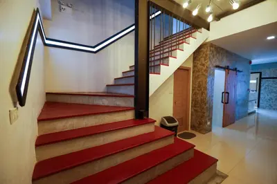 a staircase in a house with red stairs at Tall Tree Kata Phuket in Kata Beach