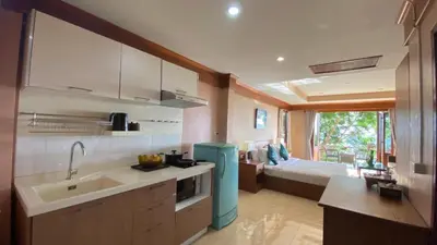 a kitchen with a sink and a bed in a room at Baan Kongdee Sunset Resort Kata in Kata Beach