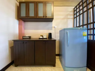 a kitchen with a blue refrigerator and a counter at Baan Kongdee Sunset Resort Kata in Kata Beach