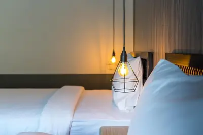 a bedroom with two white beds and a lamp at PP GRAND KAMALA HOTEL-SHA Extra Plus in Kamala Beach
