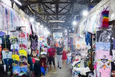 a group of people walking through a market with merchandise at Silla Patong Boutique - Beach Walk Access in Patong Beach