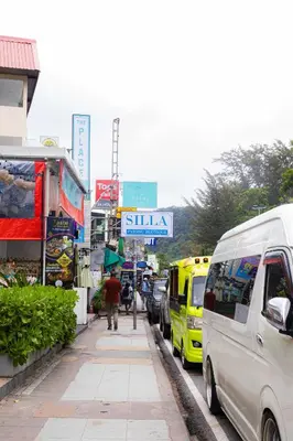 a street with cars parked on the side of the road at Silla Patong Boutique - Beach Walk Access in Patong Beach