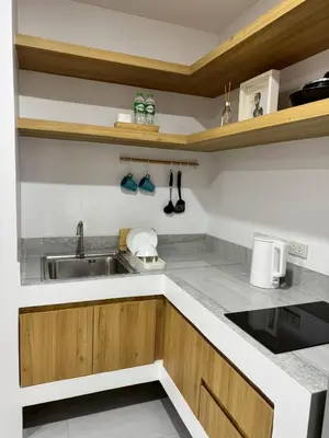 a kitchen with a sink and a counter top at Baan Trok Bedroom Studio Maikhao in Mai Khao Beach