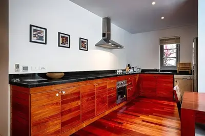 a kitchen with wooden cabinets and a table and a counter at Beautiful 3br 380sqm Pool Villa Walk To Bangtao Beach and Catch club in Bang Tao Beach