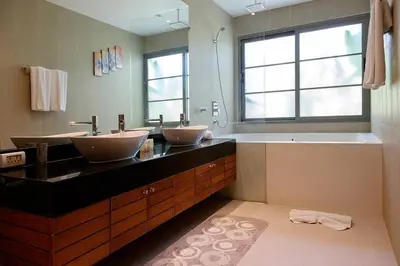 a bathroom with two sinks and a tub and a window at Beautiful 3br 380sqm Pool Villa Walk To Bangtao Beach and Catch club in Bang Tao Beach