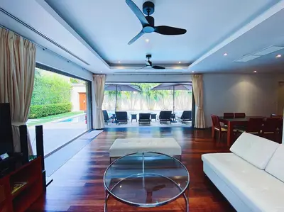 a living room with a couch and a table at Beautiful 3br 380sqm Pool Villa Walk To Bangtao Beach and Catch club in Bang Tao Beach
