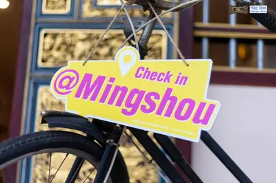 a sign that reads check in milkshake hanging on a bike at Ming Shou Boutique House in Phuket Town