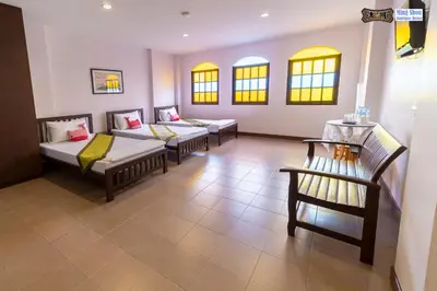 a room with three couches and chairs and windows at Ming Shou Boutique House in Phuket Town