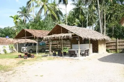 a building with a table and a van in front of it at Naga Peak Resort in Ao Nang Beach