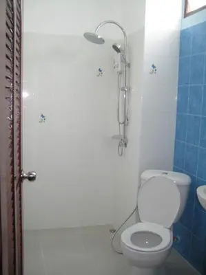 a bathroom with a white toilet and a shower at Naga Peak Resort in Ao Nang Beach