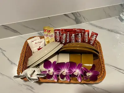 a basket filled with medicines and flowers on a counter at Sabai House in Phi Phi Don