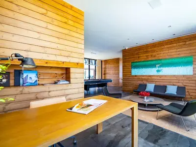 a living room with a wooden wall at Grand Villa Noi in Natai Beach